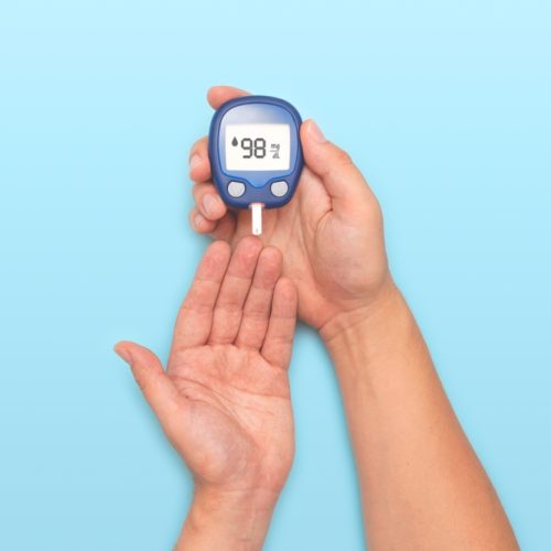 Person,Holding,A,Blue,Blood,Sugar,Monitor.,Diabetes,Concept